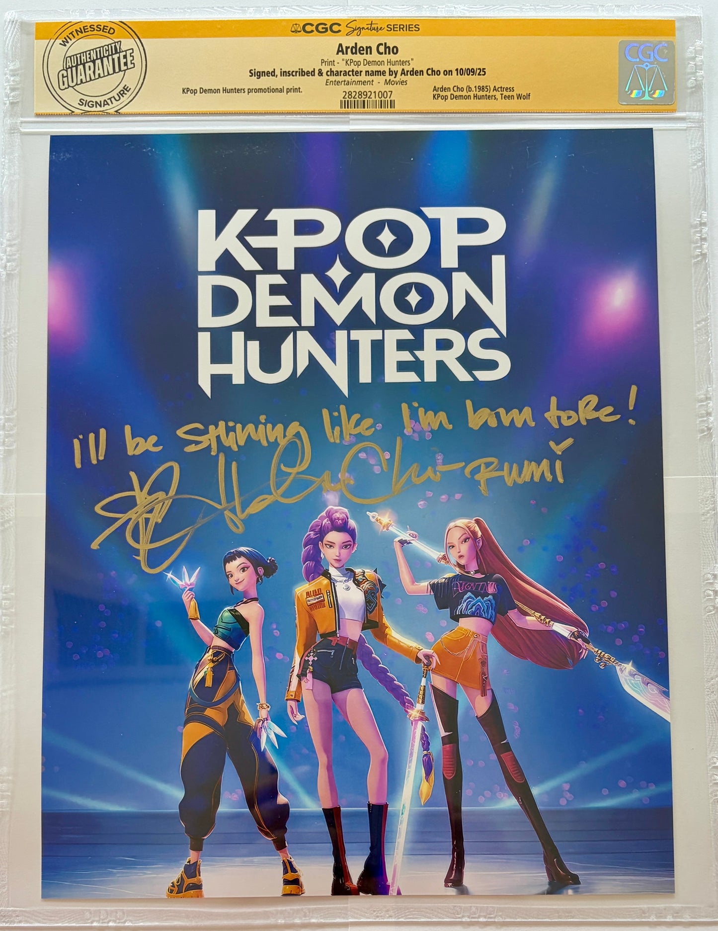 Promotional poster for 'K-Pop Demon Hunters' with three animated characters against a blue background, signed by Arden Cho.